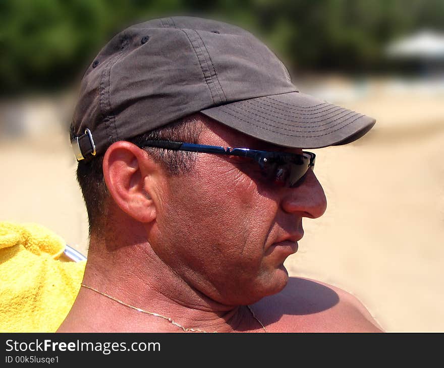 A man's headshot at the beach. Background blurred. A man's headshot at the beach. Background blurred