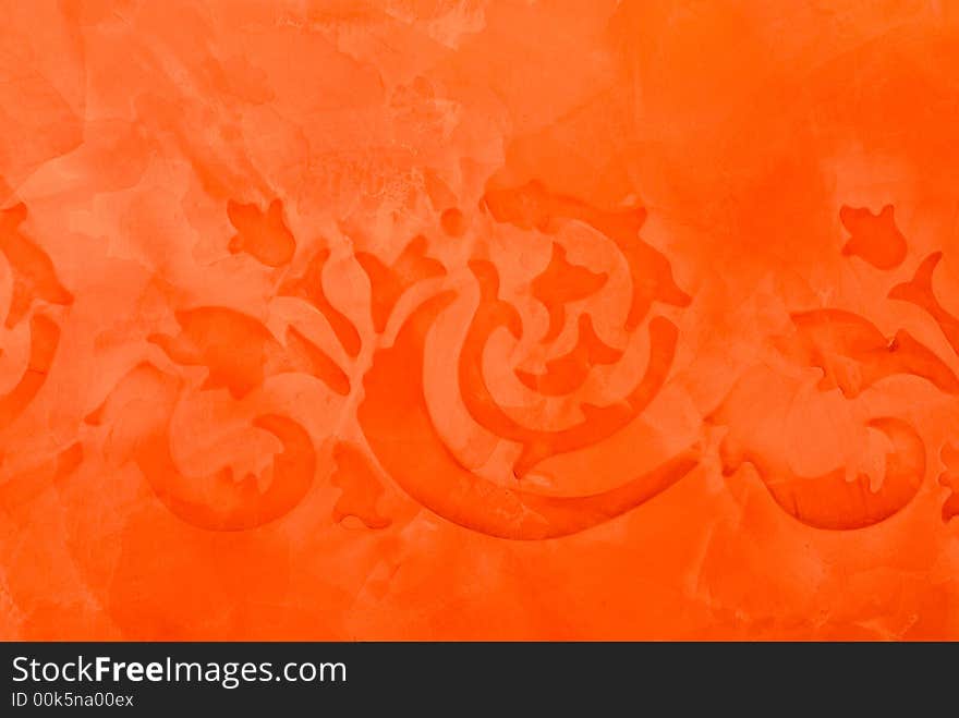 Old ancient ornamental painting detail in orange on a special primed wall as background a little blur as the origin