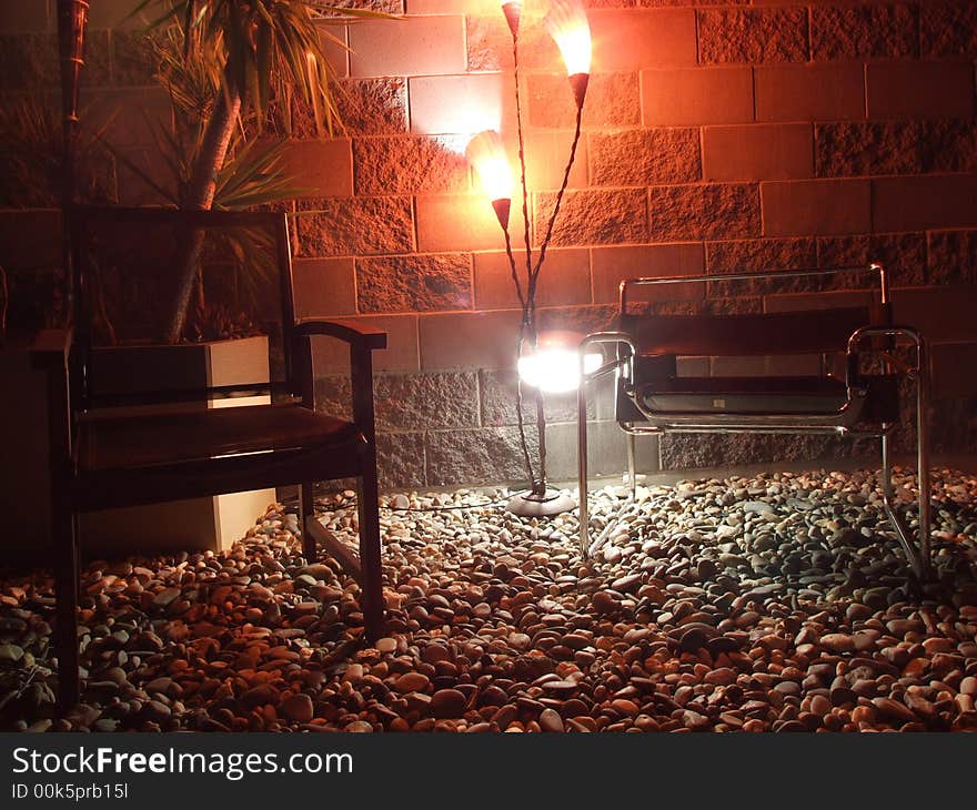 Rooftop seating area lit up at night. Rooftop seating area lit up at night