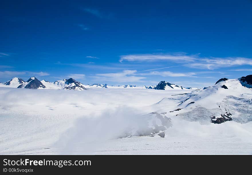 Mountain peaks above the snow and clouds near Skagway Alaska. Mountain peaks above the snow and clouds near Skagway Alaska