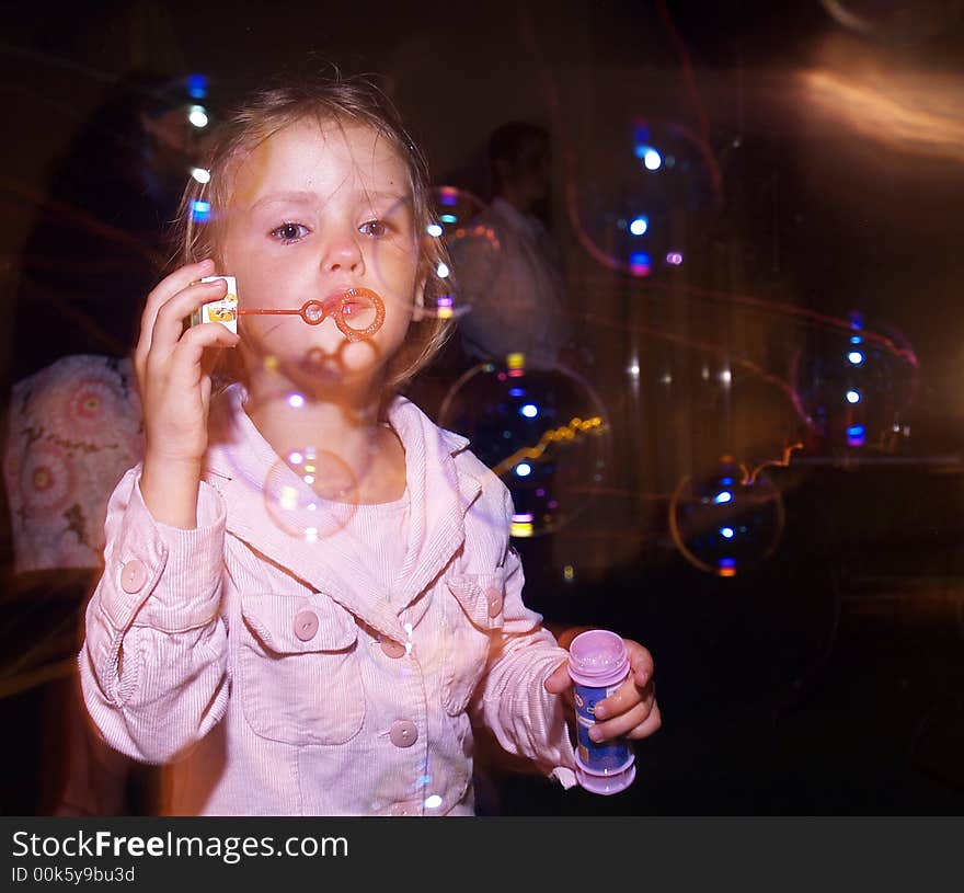 Little girl blow soap bubbles