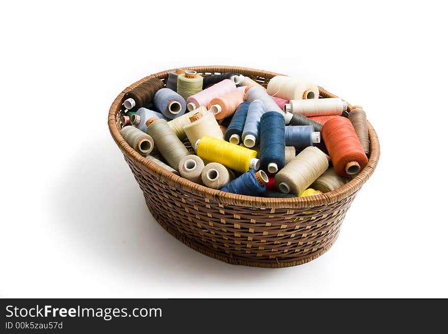 Basket with threads on white background