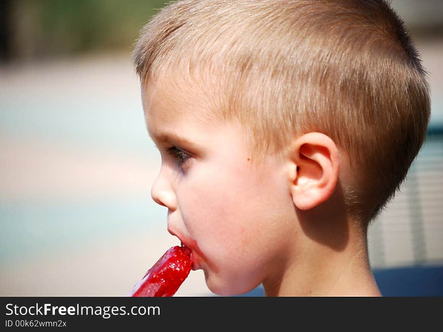 Little boy eating a popsicle. Little boy eating a popsicle