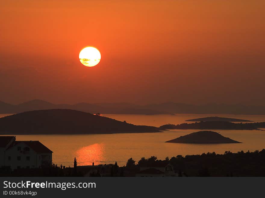 Perfect day. Sunset over island.