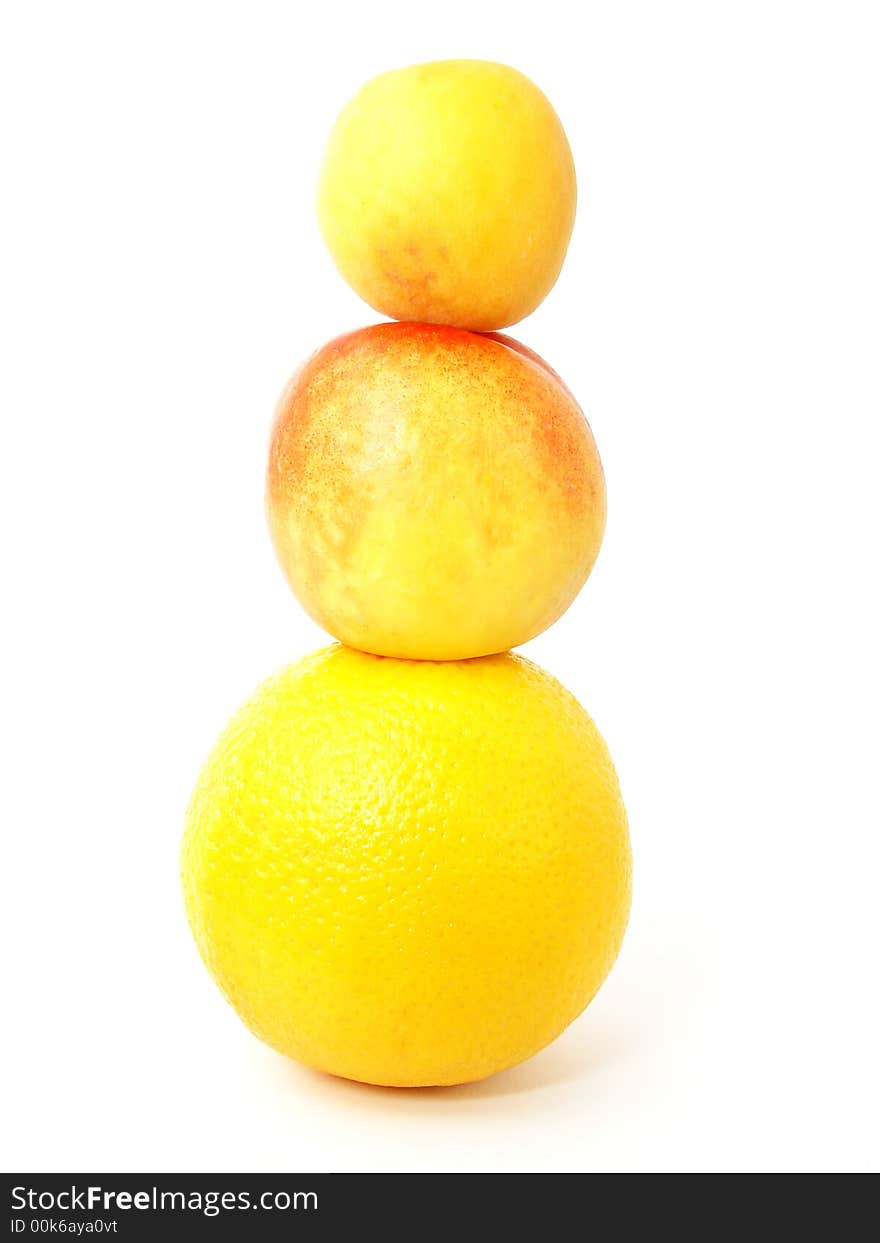 Isolated tower made from fruits: apricot, nectarine and orange. Isolated tower made from fruits: apricot, nectarine and orange