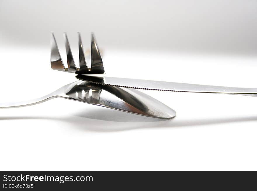 Spoon, knife and fork on white