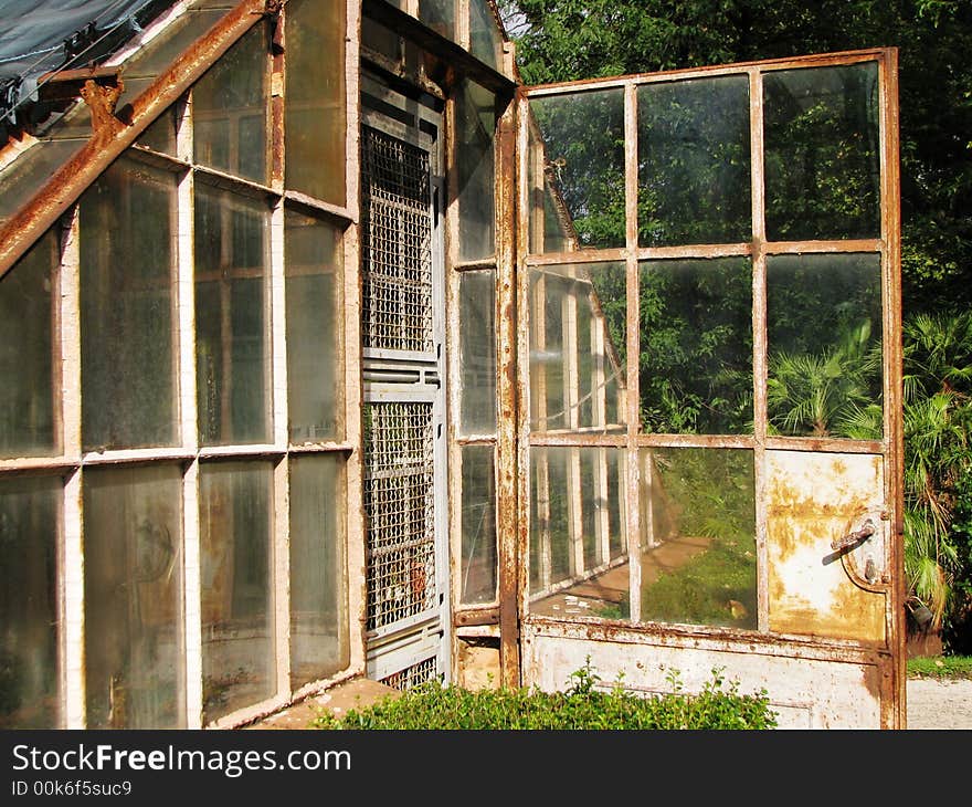 This is the old and rusty greenhouse in green park. I love it because of his dirty and large windows. This is the old and rusty greenhouse in green park. I love it because of his dirty and large windows.