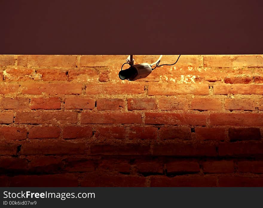 Surveillance system on the brick wall background