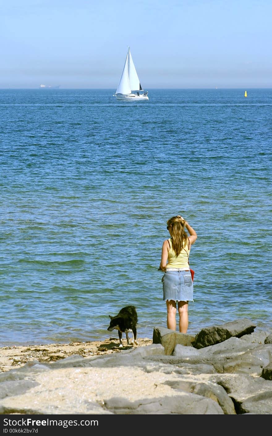 Woman and dog at St Kilda beach, Melbourne, Australia. Woman and dog at St Kilda beach, Melbourne, Australia