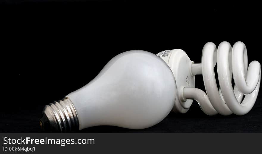 Compact fluorescent and incandescent light bulbs on black background. Compact fluorescent and incandescent light bulbs on black background