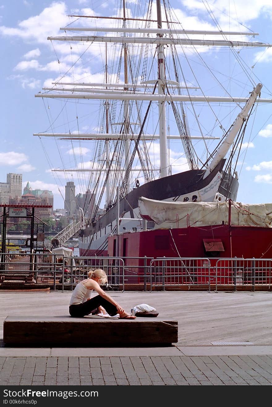 A student reads a newspaper on the New York waterfront during lunch break in the Manhattan financial district. A student reads a newspaper on the New York waterfront during lunch break in the Manhattan financial district.