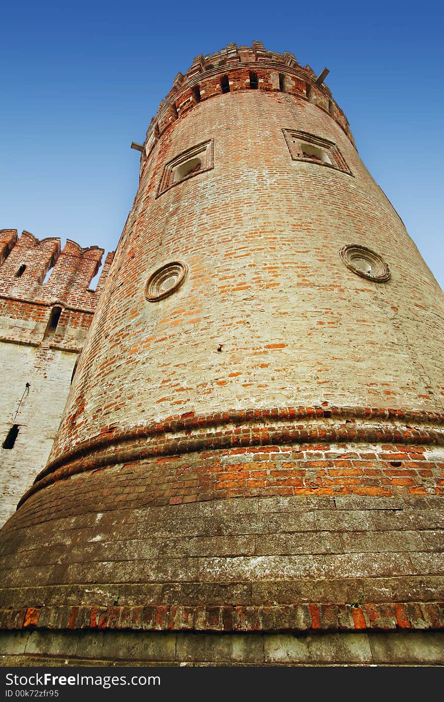 Brick tower on a background of the dark blue sky