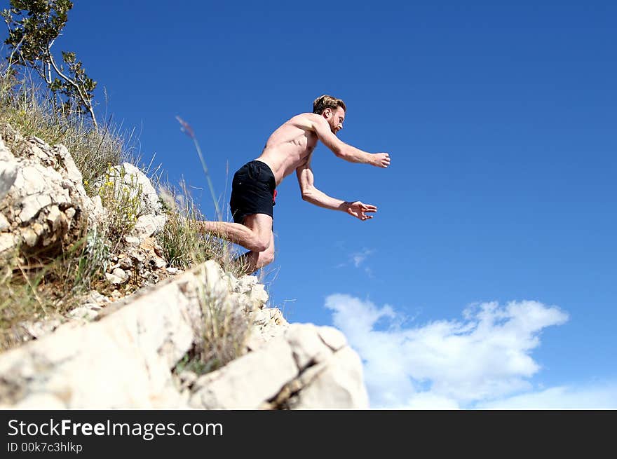 A young man jumps from a cliff into the sea!. A young man jumps from a cliff into the sea!