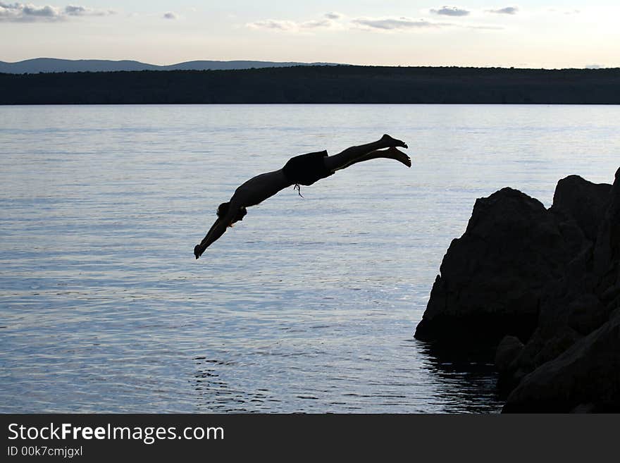 A young man jumps from a cliff into the sea!. A young man jumps from a cliff into the sea!