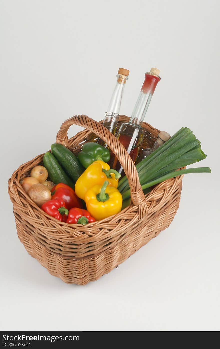 Basket with fresh vegetables and olive oil. Basket with fresh vegetables and olive oil