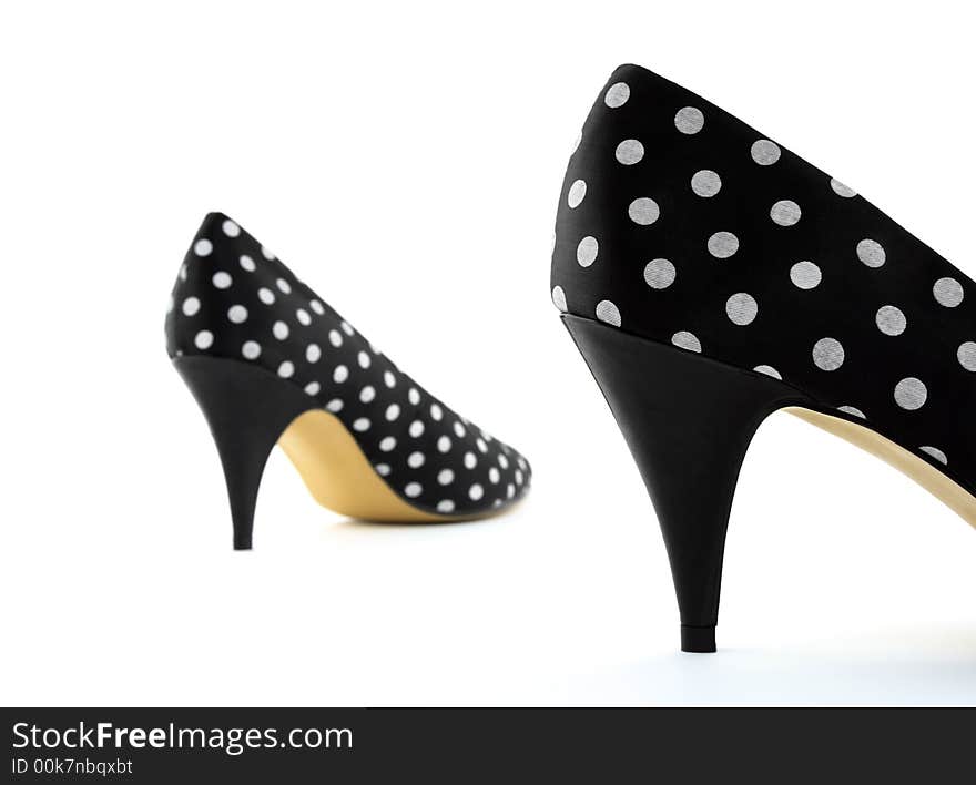 Black polka high heel shoes. Focus on the closest shoe.