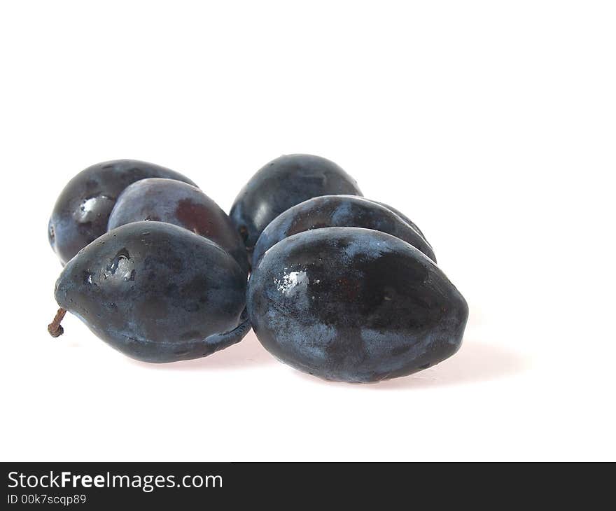Italian plums, fresh with water droplets, isolated on white background
