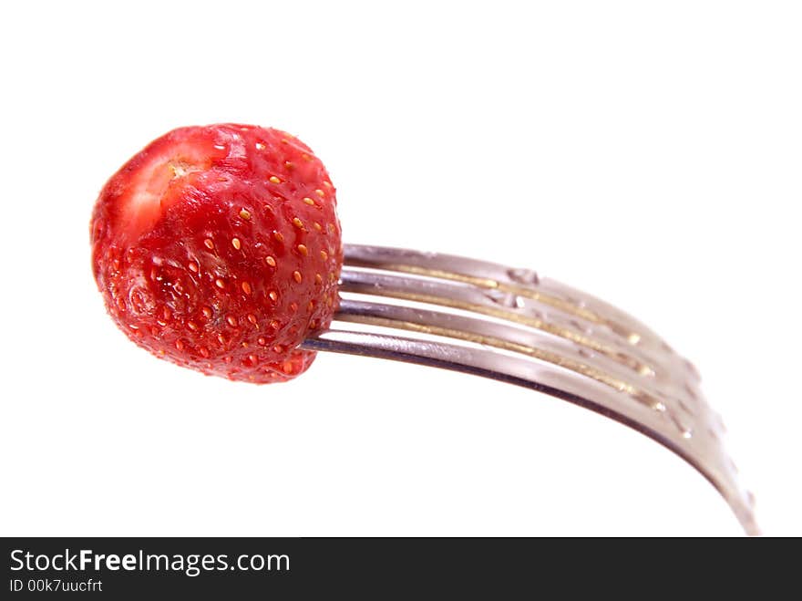 Red strawberry in a fork. Red strawberry in a fork