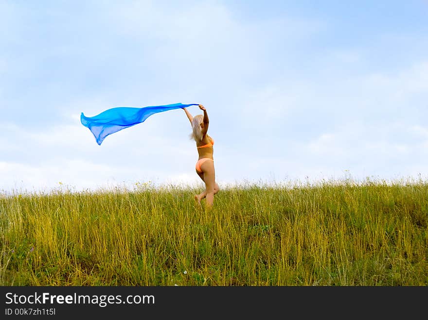 Beautiful young girl running with sarong. Beautiful young girl running with sarong