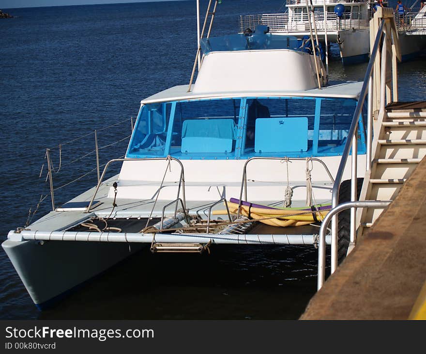 Catamarans tied to pier