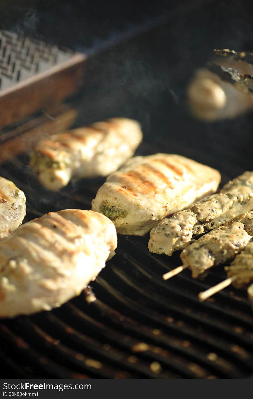 Chicken and skewered pork grilling on bbq. Chicken and skewered pork grilling on bbq