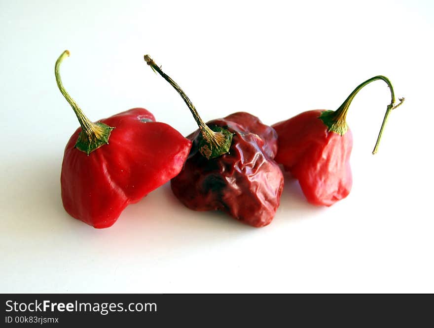 Red hot chilli peppers isolated on white background - dried out. Red hot chilli peppers isolated on white background - dried out.