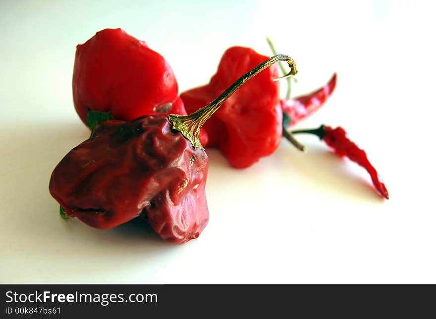 Red hot chilli peppers isolated on white background - dried out. Red hot chilli peppers isolated on white background - dried out.