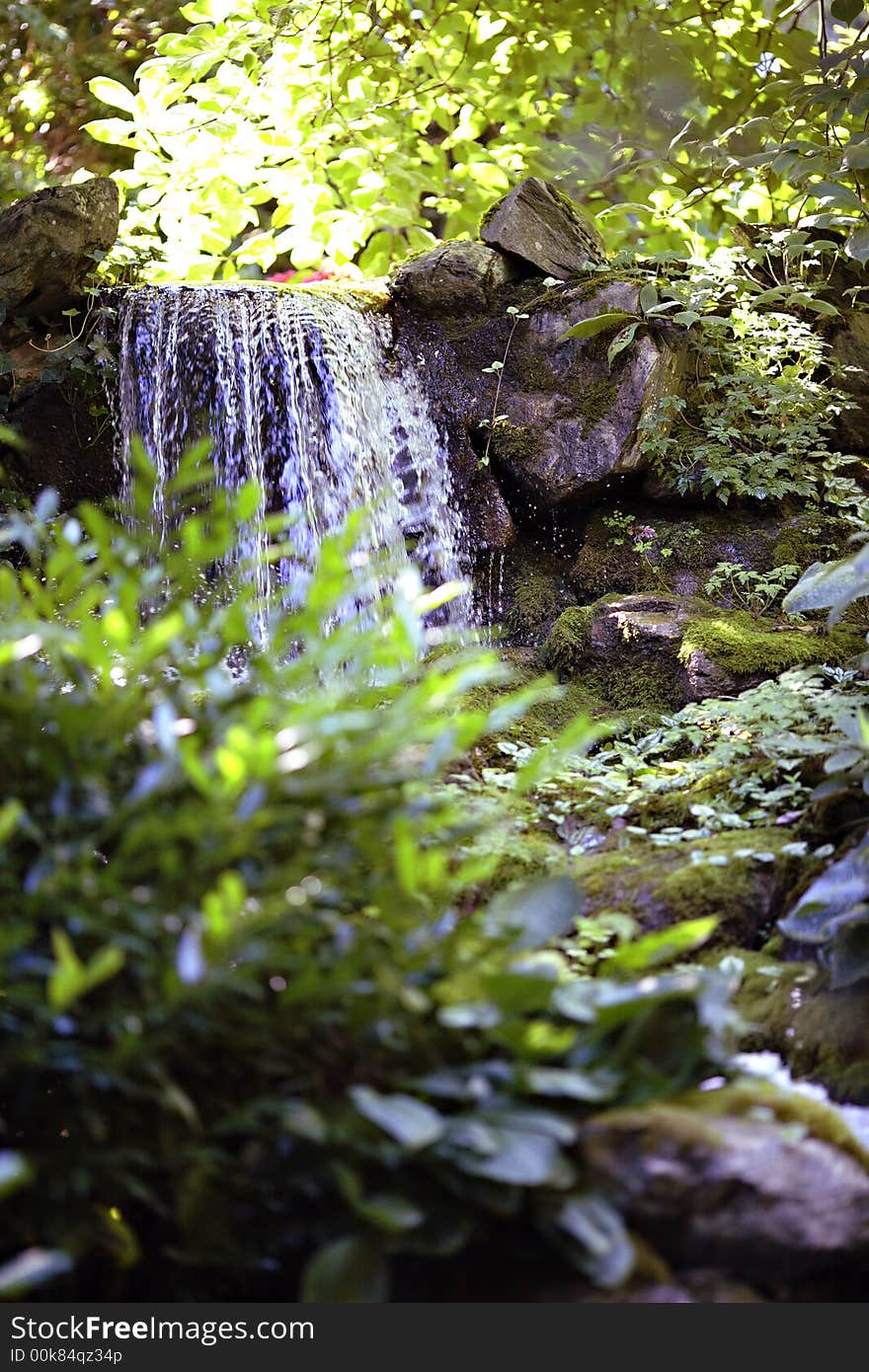 Waterfall in mountains between moss covered rocks. Waterfall in mountains between moss covered rocks