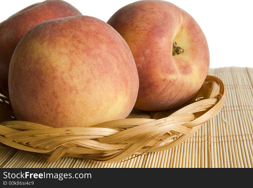 Peaches in pan on place mat isolated