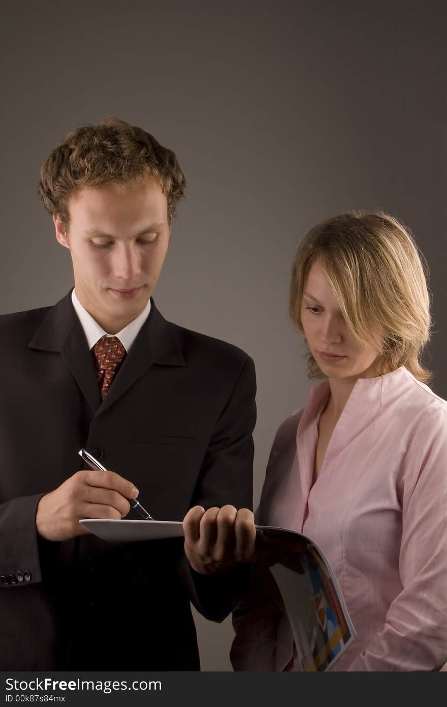 Business theme. Woman and men taking notes