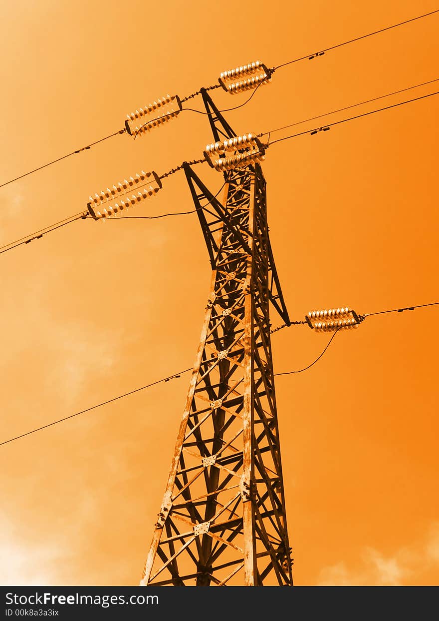 Electricity pylon on sky background, orange toning