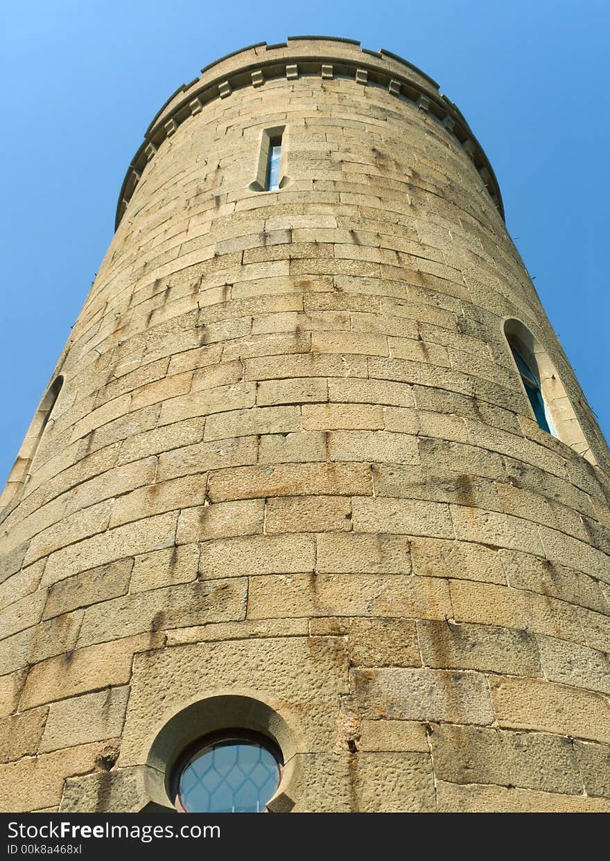 Stone tower of old castle, sky background