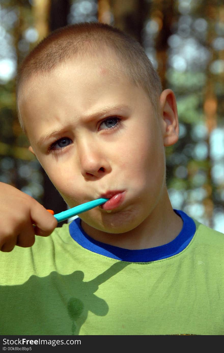 Boy is brushing his teeth