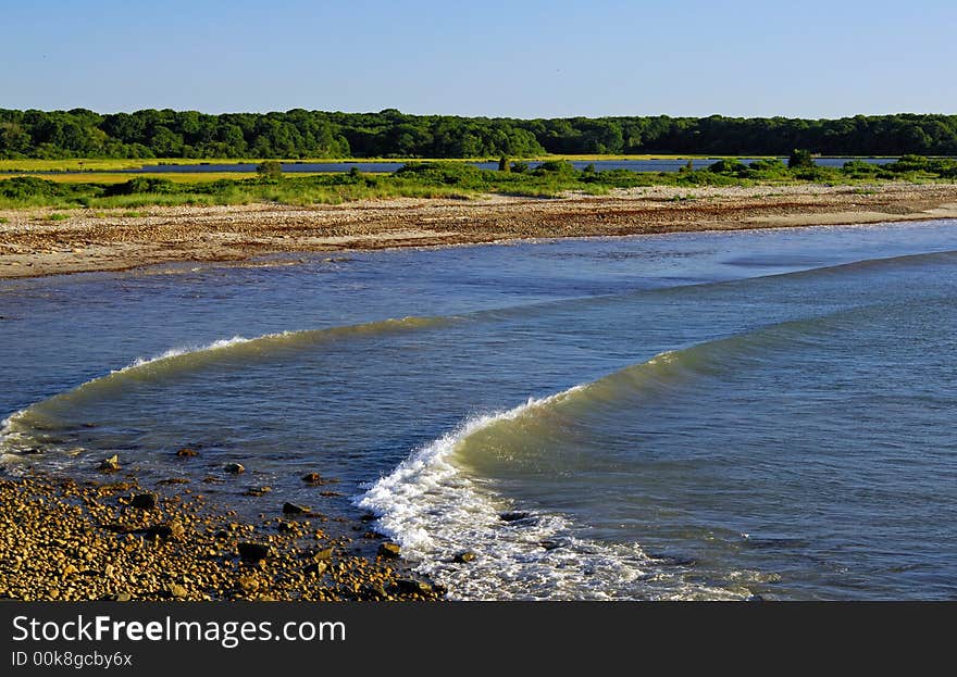 Waves break on barrier beach looking toward Allens Pond in Dartmouth, MA, USA. Waves break on barrier beach looking toward Allens Pond in Dartmouth, MA, USA