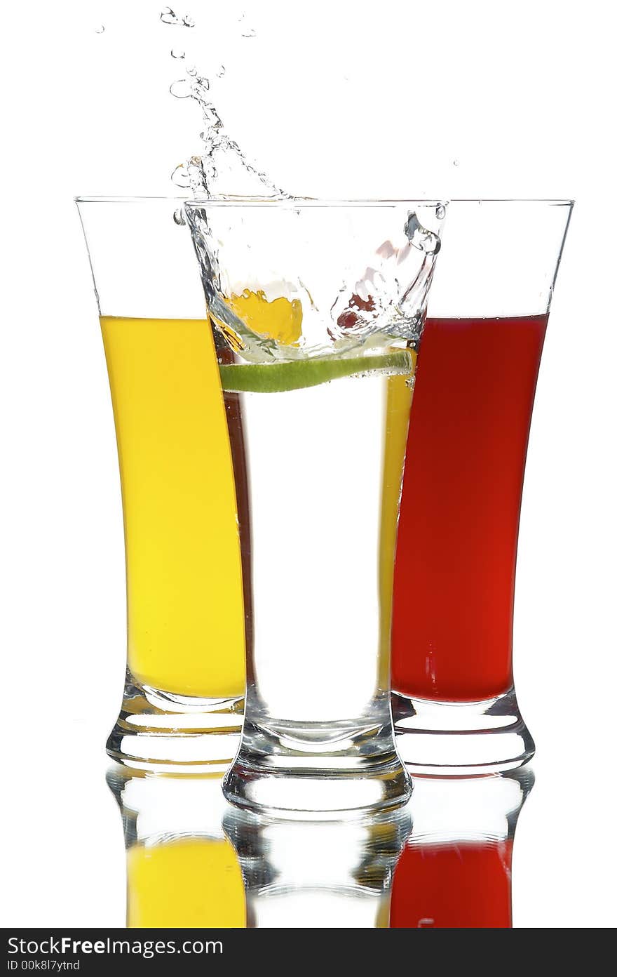 Glasses with juice and lime on the white background