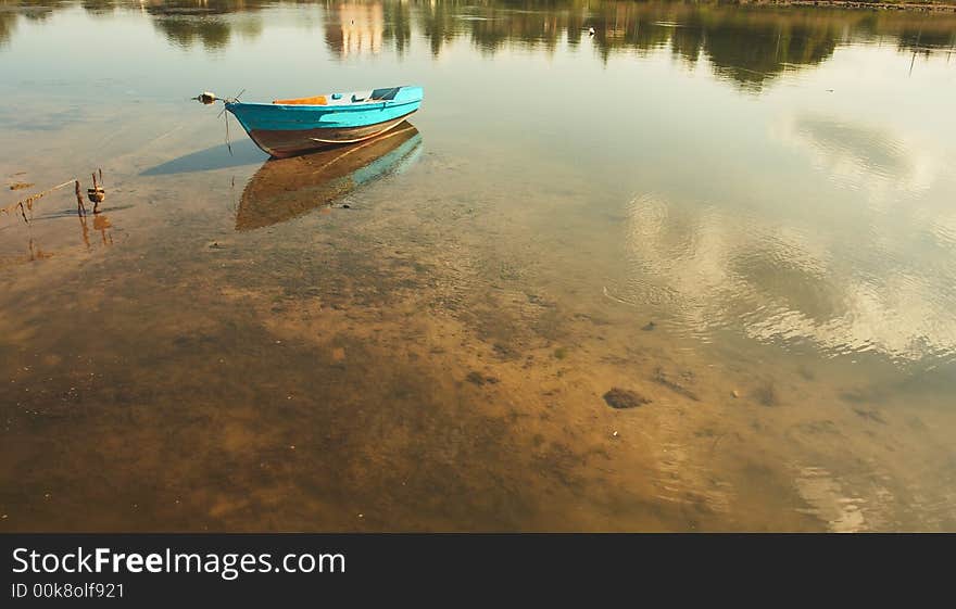 Sea landscape with reflection of clouds and a boat. Sea landscape with reflection of clouds and a boat