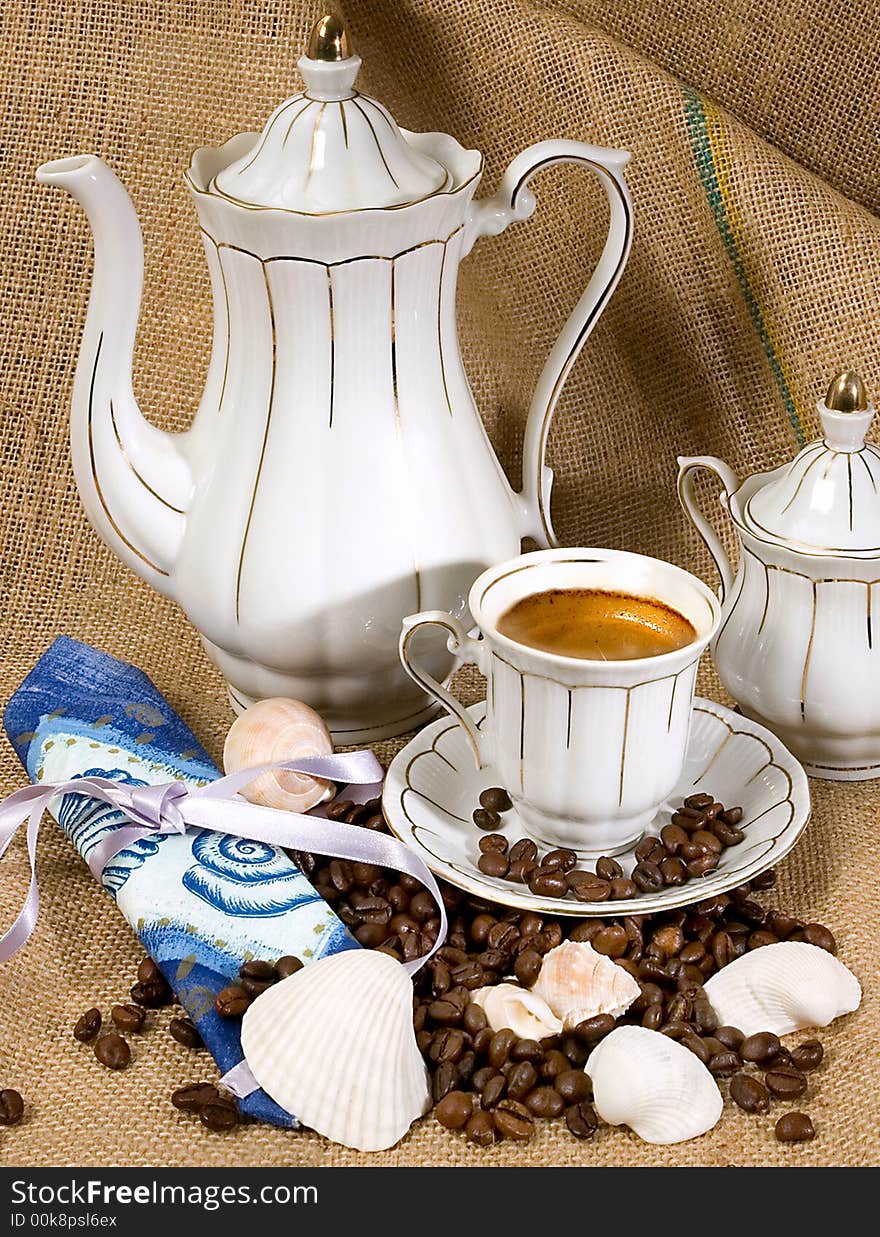 Retro style coffee cup and coffee beans with shells