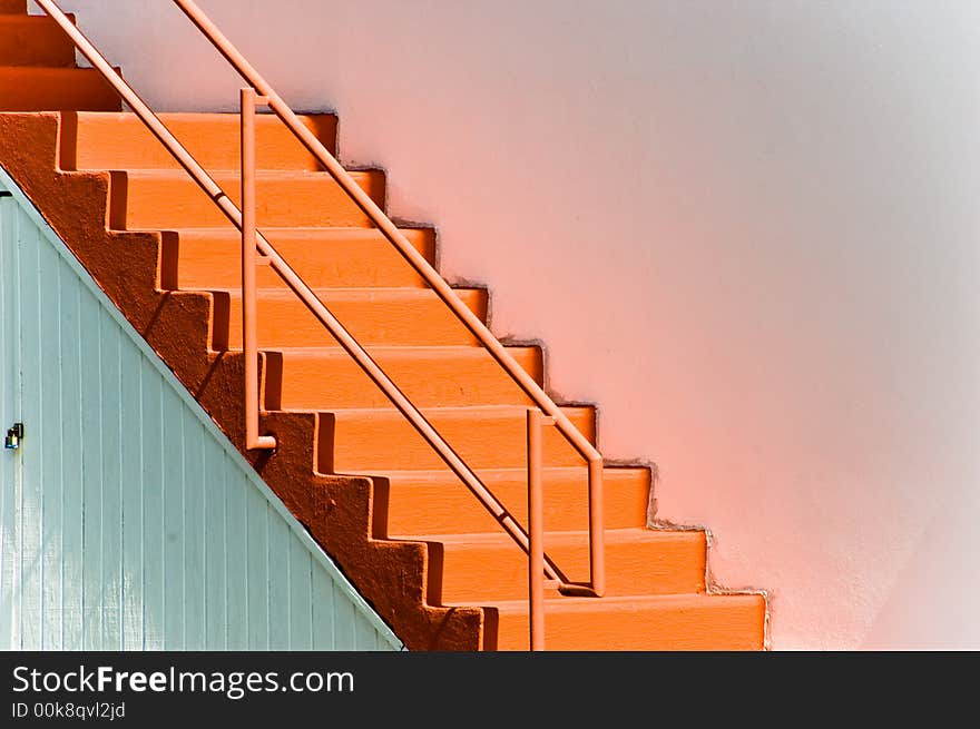 Pink staircase against a white wall