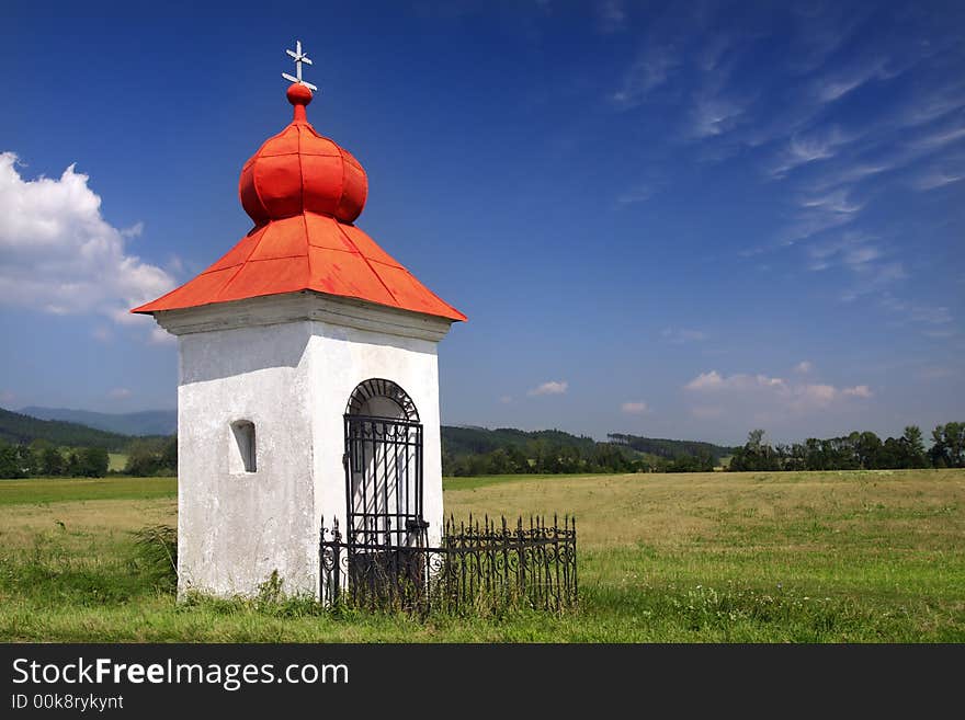 Rustic Christian chapel with red roof