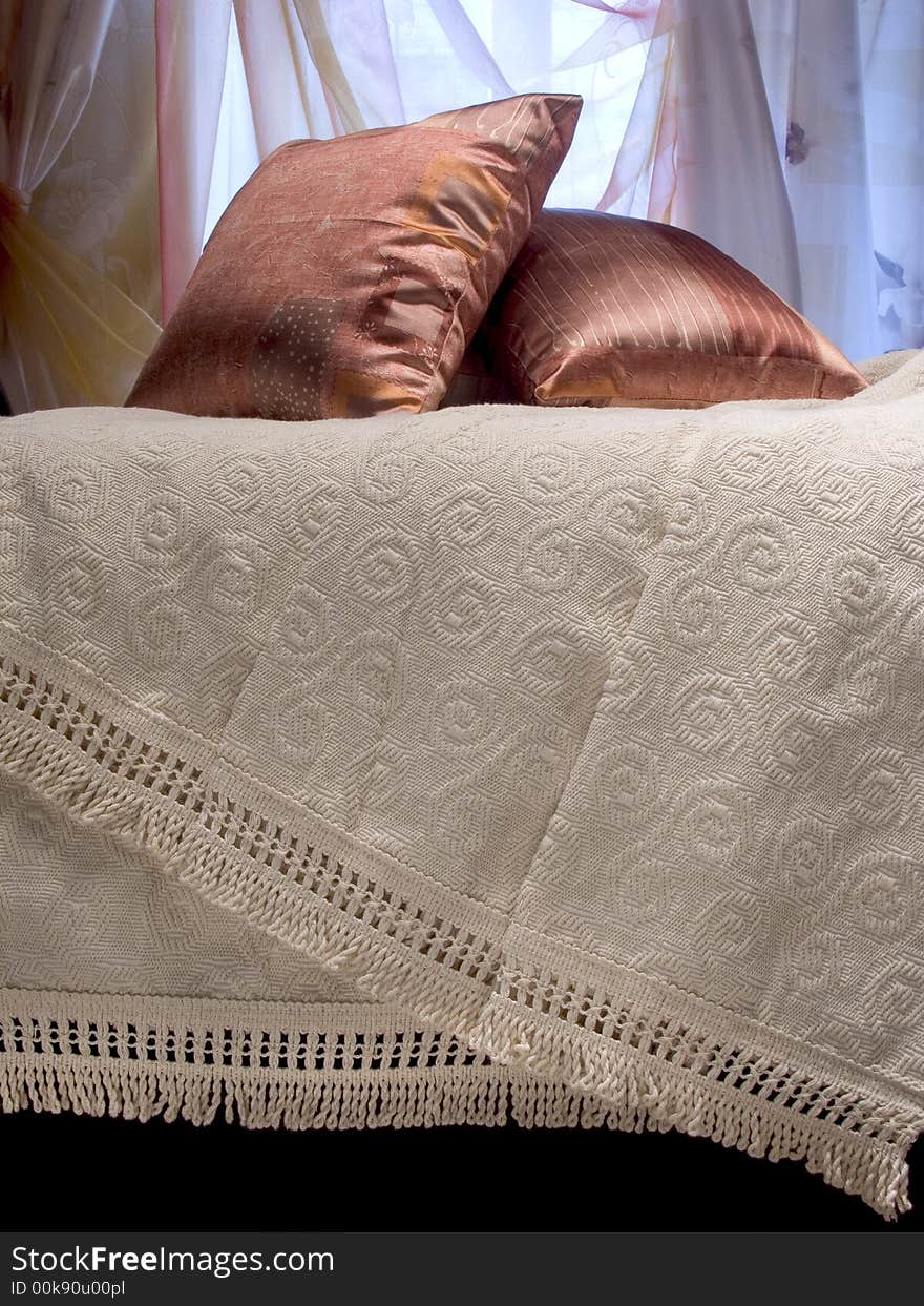 Two brown pillows on a coverlet. Two brown pillows on a coverlet