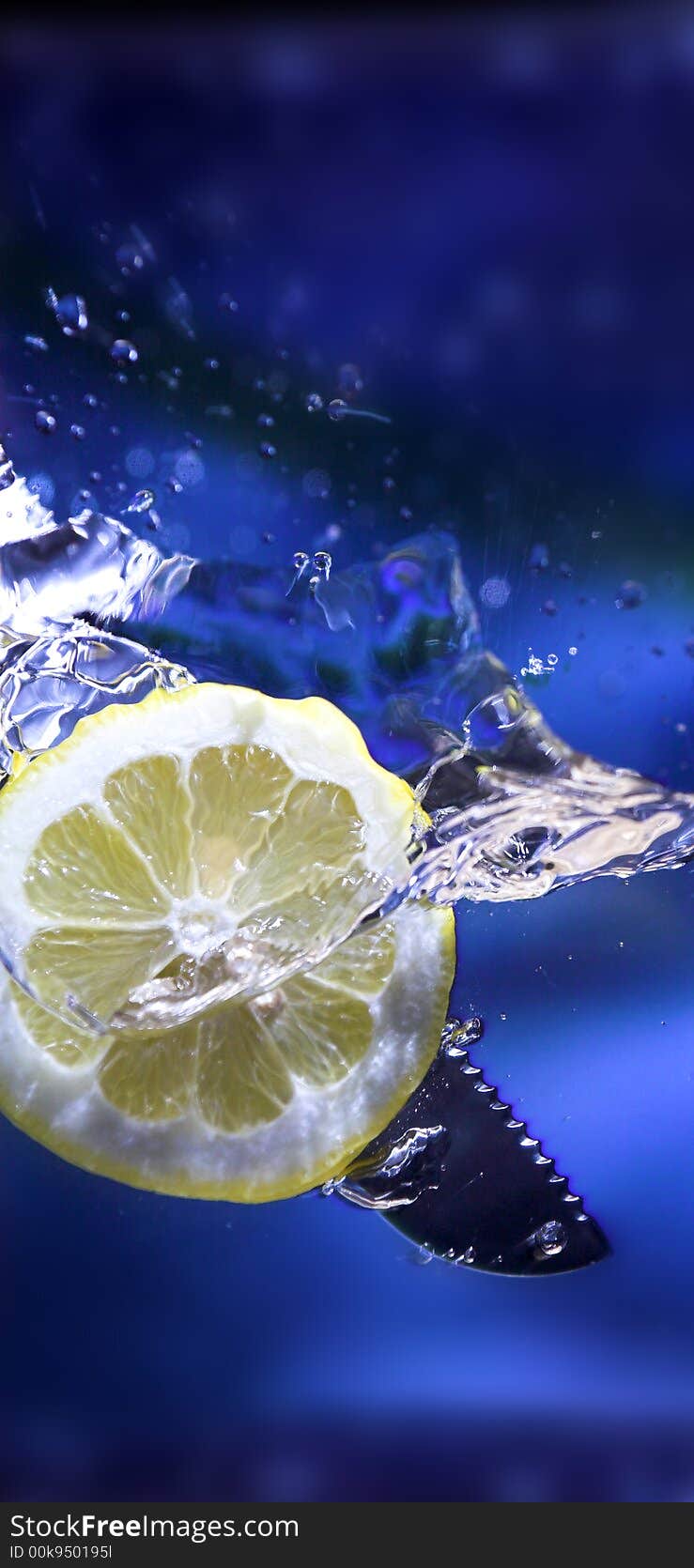 Lemon splash in transparent glass over blue background