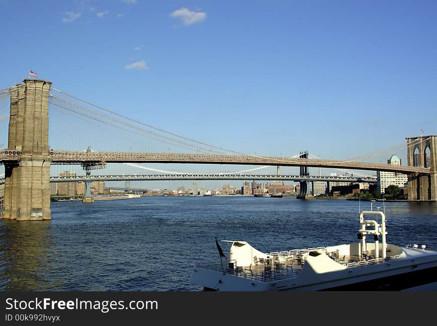 Brooklyn bridge Manhattan New York with boat in foreground