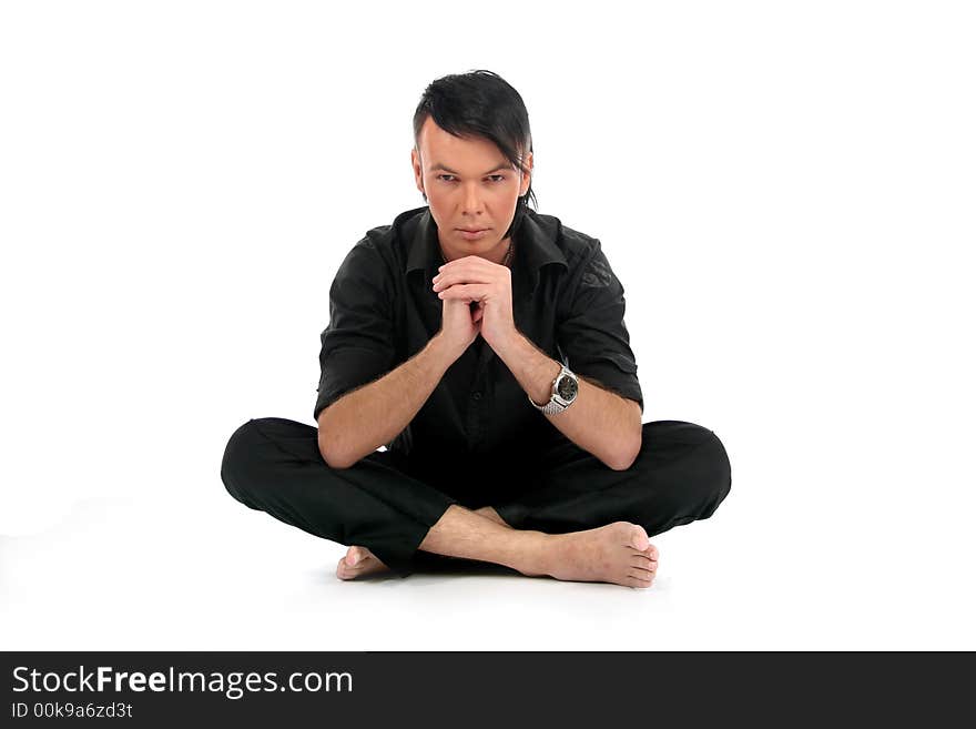 Young attractive man sits in front of camera. Young attractive man sits in front of camera