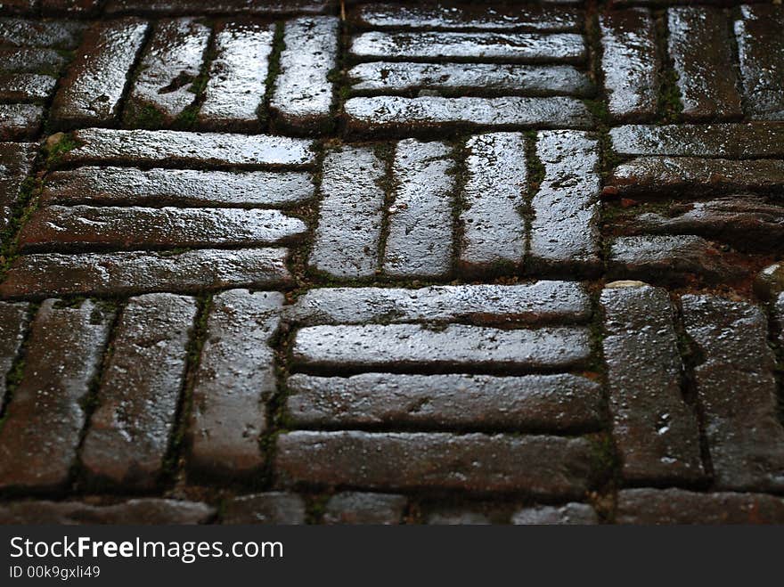 A close-up image of a wet stone side walk in thailand. A close-up image of a wet stone side walk in thailand