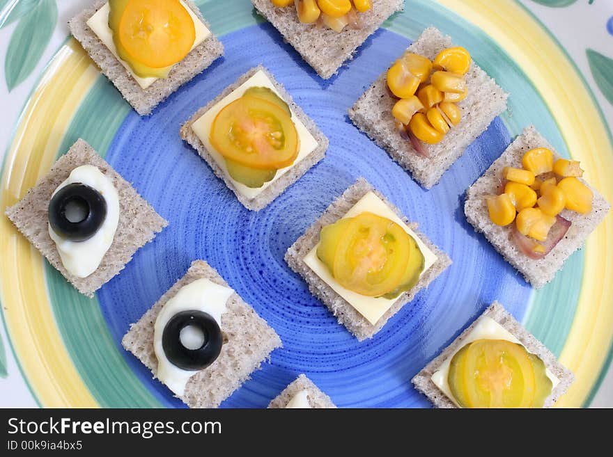 Fruit and vegetable canapes on a white ceramic plate