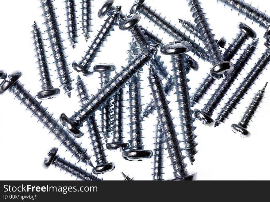 Macro Close-Up Of Spiral Metal Screws On A White Background