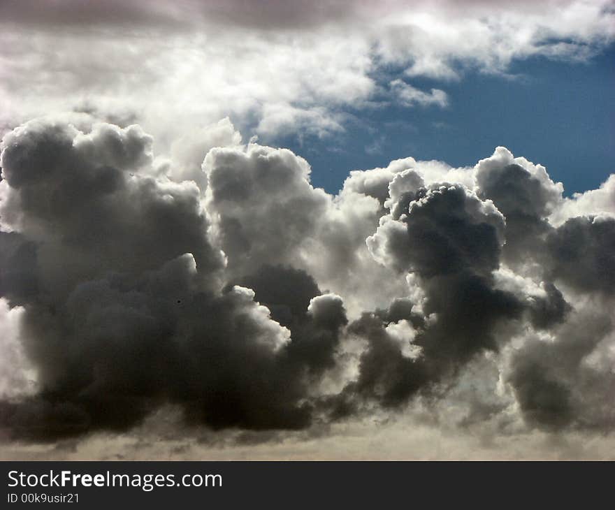 Dark clouds growing against a blue sky