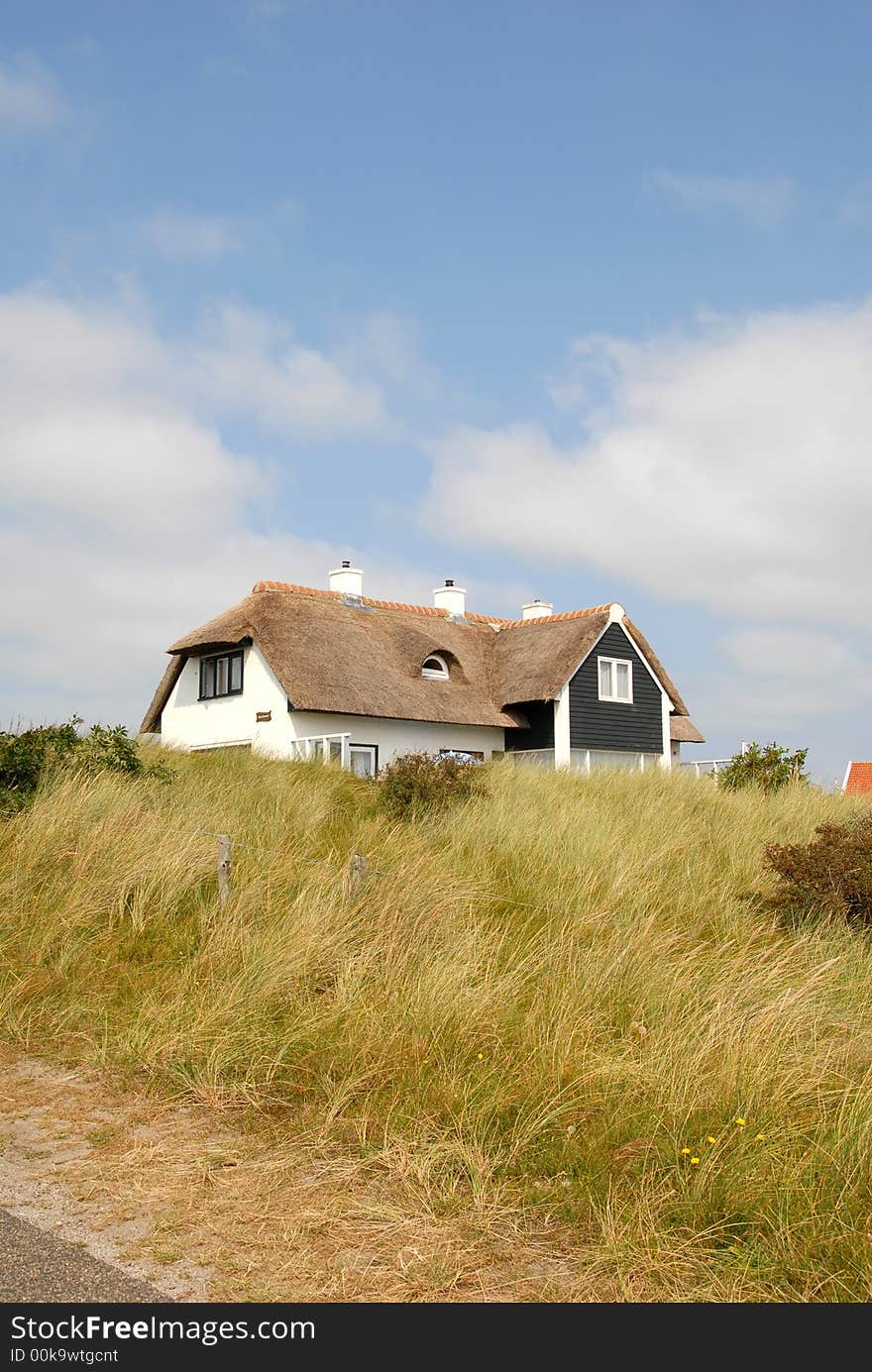 Farm house is standing in grass dunes