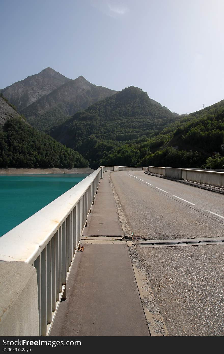 A highway in the mountains with a beautiful blue lake. A highway in the mountains with a beautiful blue lake.