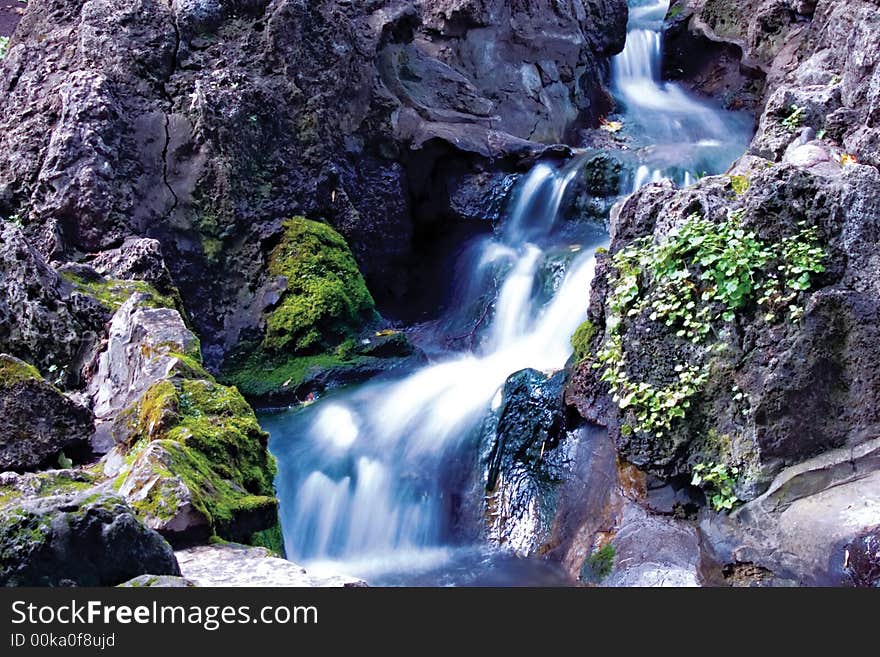 Small picturesque waterfalls in rocks